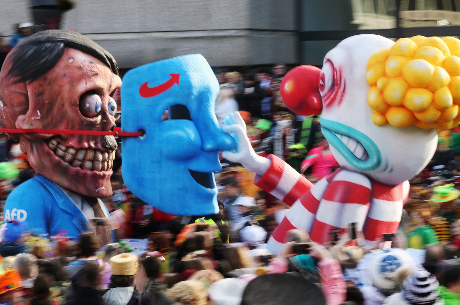 A carnival float depicting a clown lifting a German far-right AfD party mask from the face of Adolf Hitler seen in Duesseldorf, Germany, Feb. 12, 2024. (EPA Photo)
