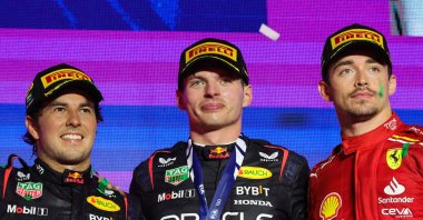 Red Bull Racing's Dutch driver Max Verstappen (C) celebrates winning the Saudi Arabian Formula One Grand Prix alongside Sergio Perez (L) and Charles Leclerc during the podium ceremony at the Jeddah Corniche Circuit, Jeddah, Saudi Arabia, March 9, 2024. (AFP Photo)