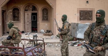 YPG/PKK terrorists are seen in front of a building in Baghouz, Syria, March 24, 2019. (Getty Images, File Photo)