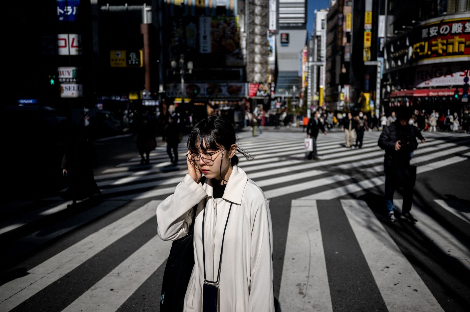 Pedestrians walk in the Shinjuku district of Tokyo, Japan, Feb. 13, 2024. (AFP Photo)