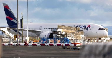 The LATAM Airlines Boeing 787 Dreamliner plane that suddenly lost altitude midflight a day earlier, dropping violently and injuring dozens of terrified travelers, is seen on the tarmac of Auckland International Airport, Auckland, New Zealand, March 12, 2024. (AFP Photo)