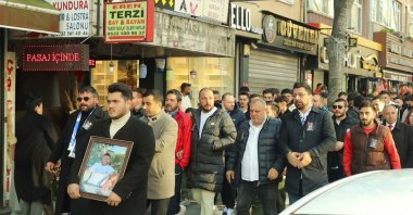 People carrying the photo of Oğuz Aci, the only victim of the accident, attend a walk calling for justice, Istanbul, Türkiye, March 10, 2024. (IHA Photo)