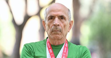 Turkish marathoner Yakup Orhan, 76, poses for a photo after an interview with Anadolu Agency (AA), Istanbul, Türkiye, March 11, 2024. (AA Photo)