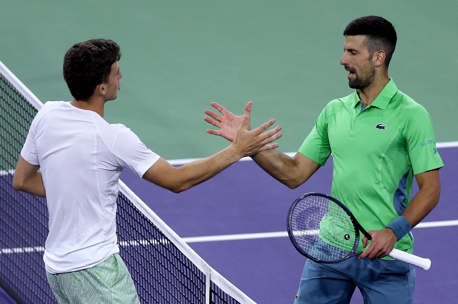 Italy&#039;s Luca Nardi is congratulated by Serbia&#039;s Novak Djokovic after their match during the BNP Paribas Open at Indian Wells Tennis Garden, Indian Wells, U.S., March 11, 2024. (AFP Photo)