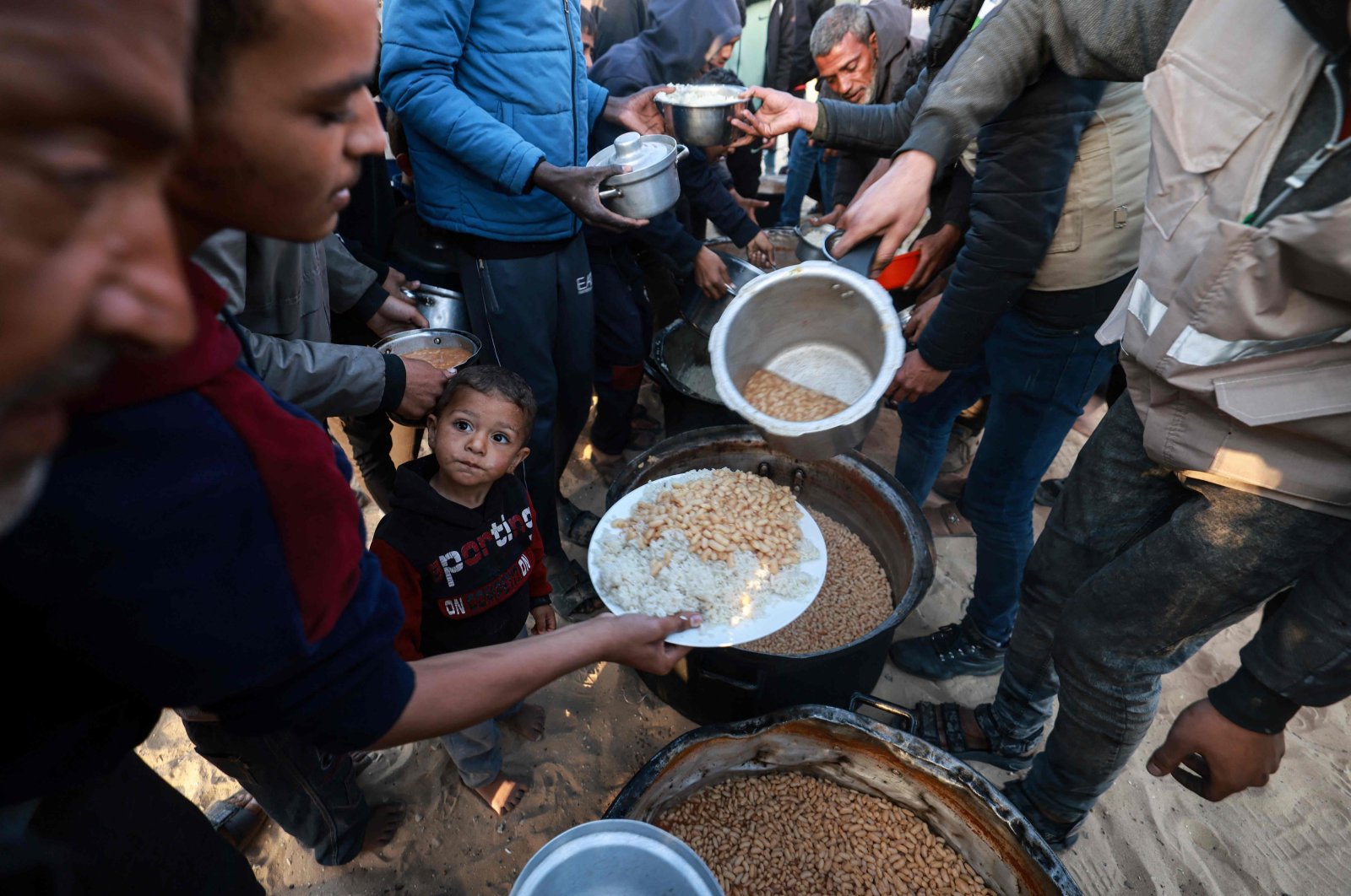 Displaced Palestinians collect food donated by a charity in Rafah, southern Gaza Strip, Palestine, March 11, 2024. (AFP Photo)