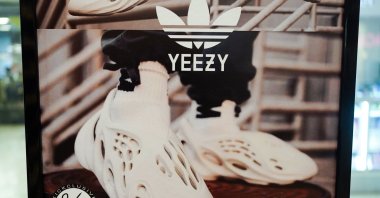 A sign advertises Yeezy shoes made by Adidas at Kickclusive, a sneaker resale store, in Paramus, N.J., U.S., Oct. 25, 2022. (AP Photo)