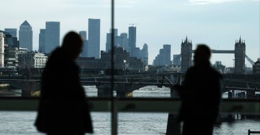Commuters are silhouetted in front of the city of London, Britain, Feb. 15, 2024. (EPA Photo)