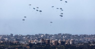 This picture taken from Israel's southern border with the Gaza Strip shows humanitarian aid being airdropped over the Palestinian territory on March 13, 2024. (AFP Photo)