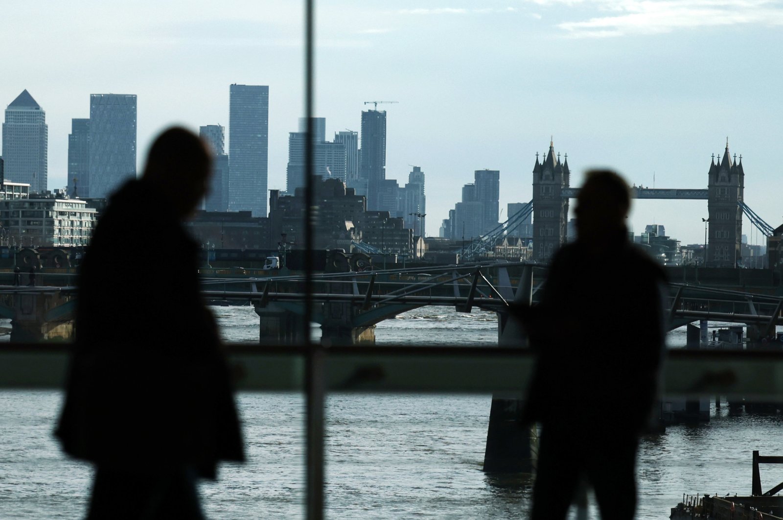 Commuters are silhouetted in front of the city of London, Britain, Feb. 15, 2024. (EPA Photo)