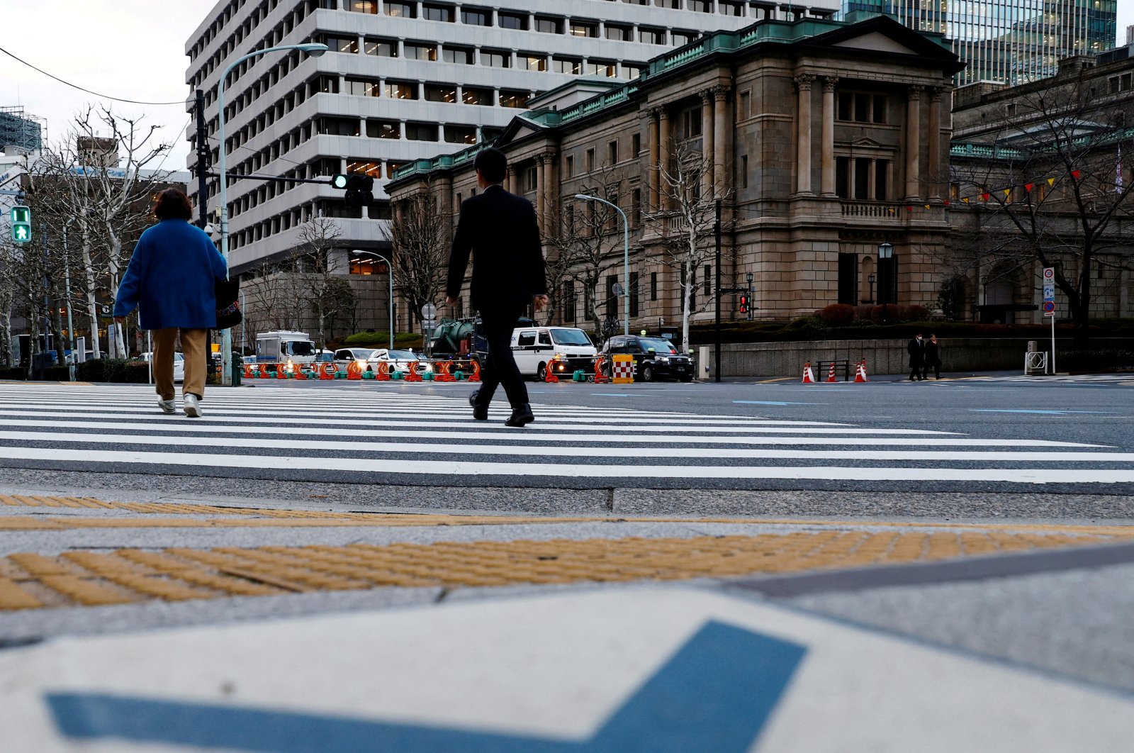 People walk in front of the Bank of Japan (BOJ) building in Tokyo, Japan, Jan. 23, 2024. (Reuters Photo)