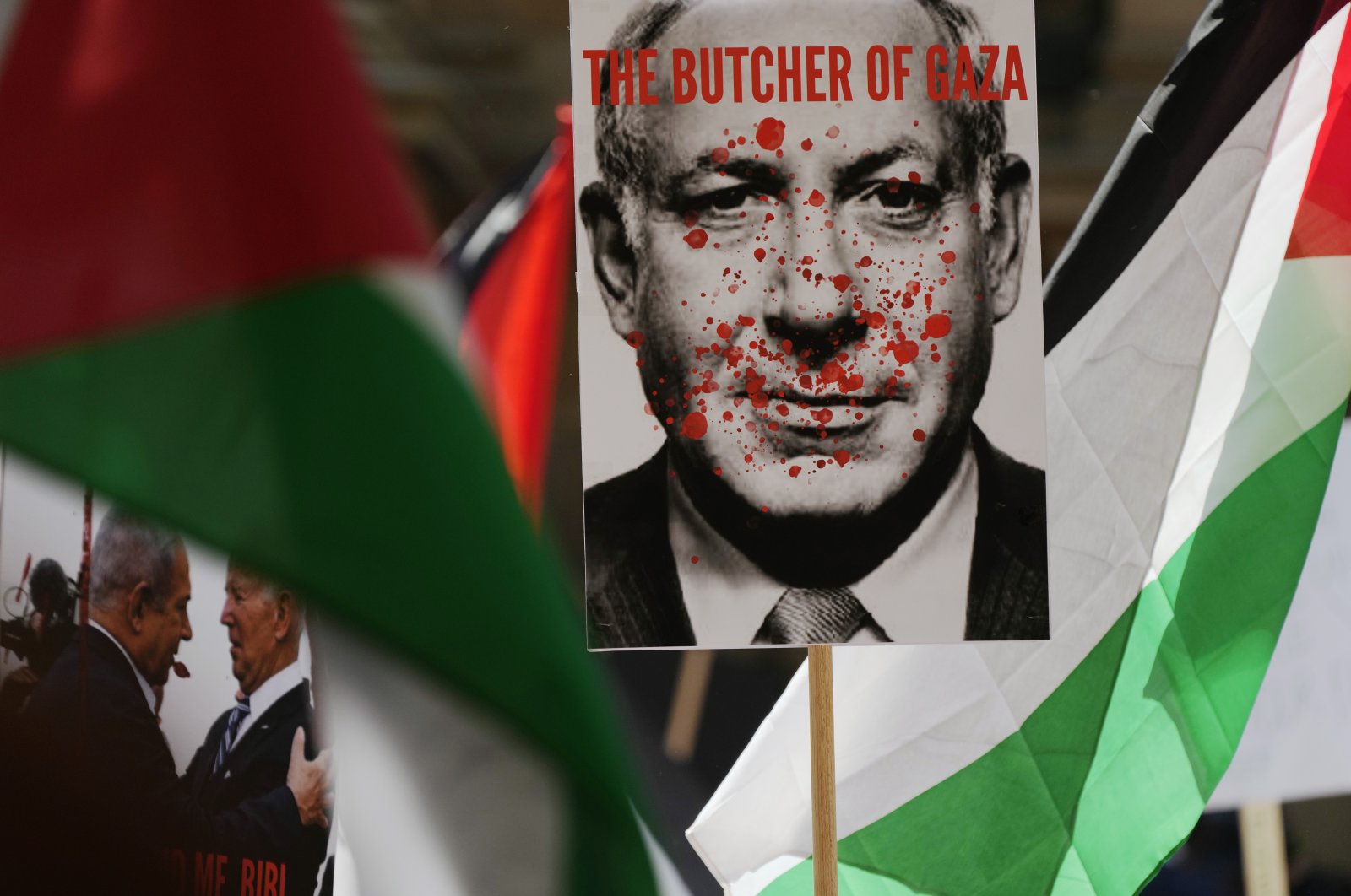 The poster shows Israeli Prime Minister Benjamin Netanyahu carried among Palestinian flags during a pro-Palestinian rally in Sydney, Australia, Oct. 21, 2023. (AP Photo)