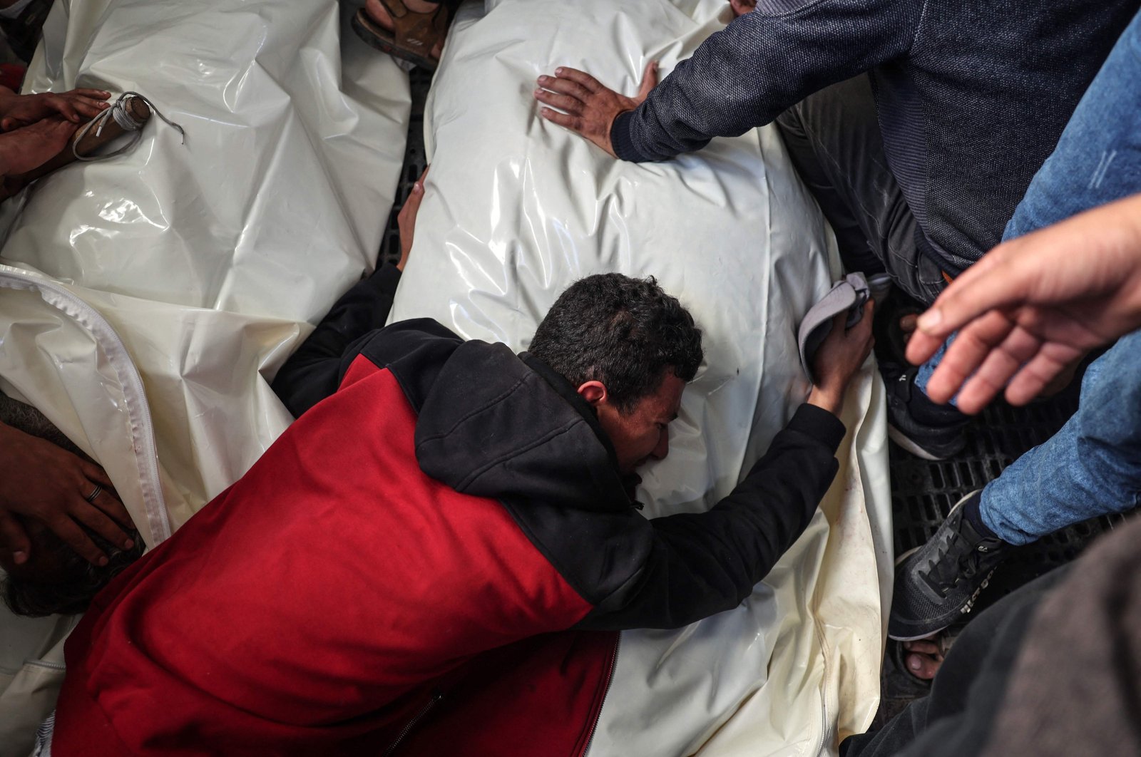 A Palestinian man mourns over the body of a loved one at al-Najjar Hospital in Rafah, in the southern Gaza Strip, Palestine, March 13, 2024. (AFP Photo)