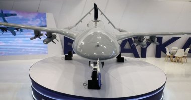 Bayraktar TB2 drone stands near the logo of Baykar Turkish defense company inside a hall of the 30th International Defence Industry Exhibition in Kielce, Poland, Sept. 5, 2022. (Reuters Photo)
