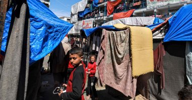 Sheets showing greeting messages for the Islamic holy month of Ramadan hang outside buildings at a refugee camp in Rafah, southern Gaza Strip, Palestine, March 13, 2024. (AFP Photo)