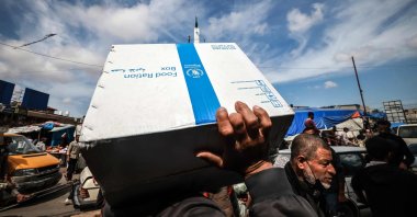 Displaced Palestinians carry a box of food rations provided by the World Food Programme in Rafah, southern Gaza Strip, Palestine, March 14, 2024. (AFP Photo)