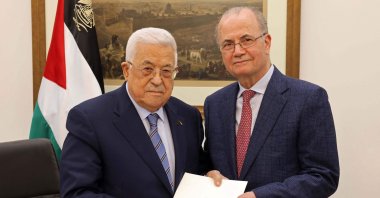 This handout picture provided by the Palestinian Authority's Press Office (PPO) shows Palestinian President Mahmoud Abbas (L) posing with the newly appointed Palestinian Prime Minister Mohammad Mustafa in Ramallah on March 14, 2024. (AFP Photo)