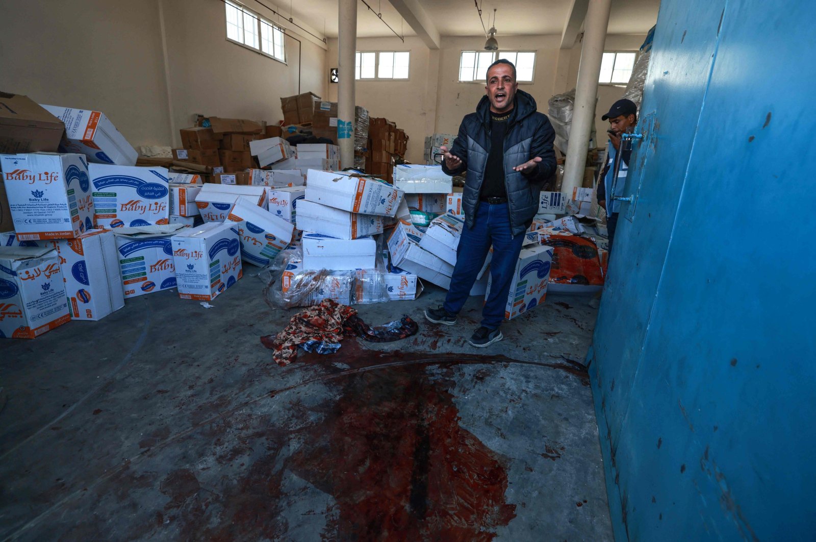 A man gestures near a pool of blood at a U.N. warehouse targeted by Israel, in Rafah, southern Gaza Strip, Palestine, March 13, 2024. (AFP Photo)
