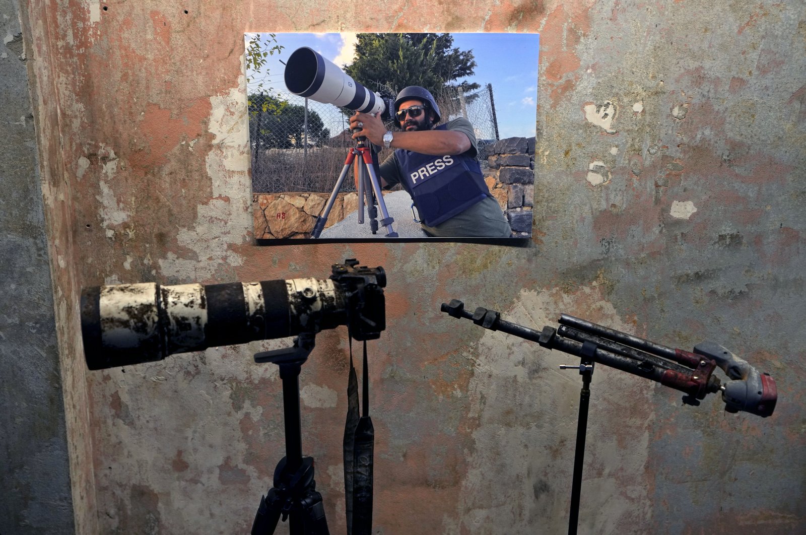 A poster of Reuters videographer Issam Abdallah, who was killed by Israeli shelling on Oct. 13, 2023, with his camera and tripod is displayed during a press conference by Amnesty International and Human Rights Watch in Beirut, Lebanon, Dec. 7, 2023. (AP Photo)