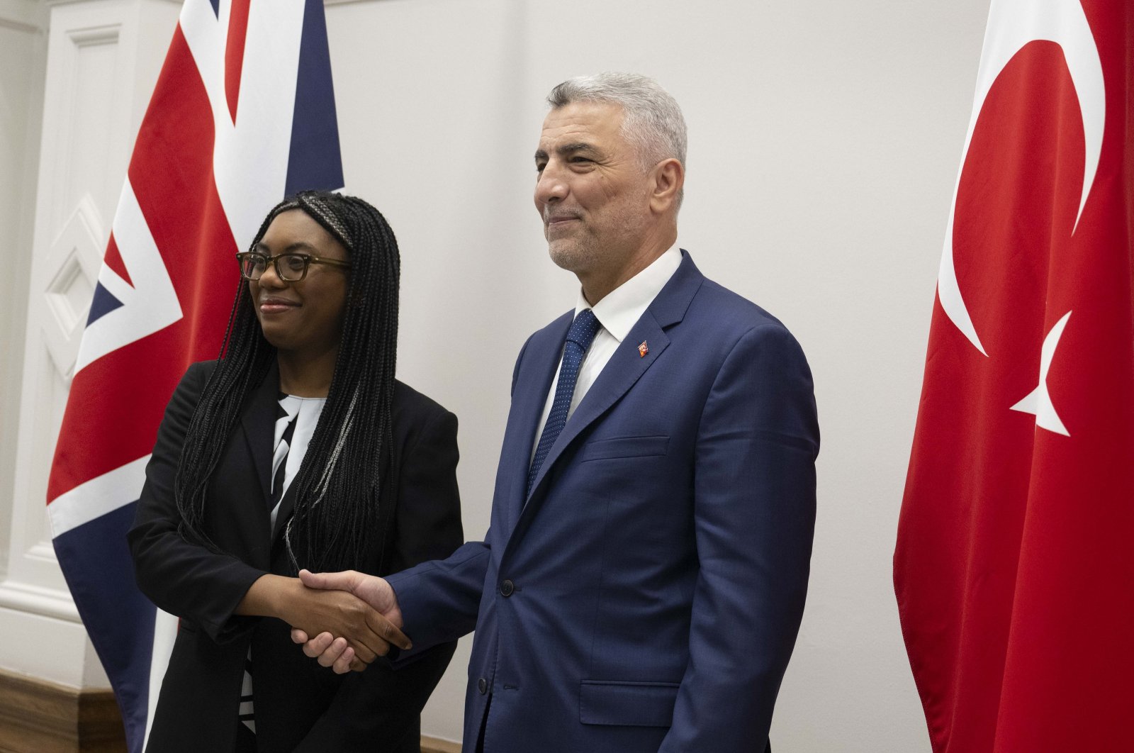 Trade Minister Ömer Bolat shakes hands with U.K. Business and Trade Secretary Kemi Badenoch, London, U.K., March 14, 2024. (AA Photo)