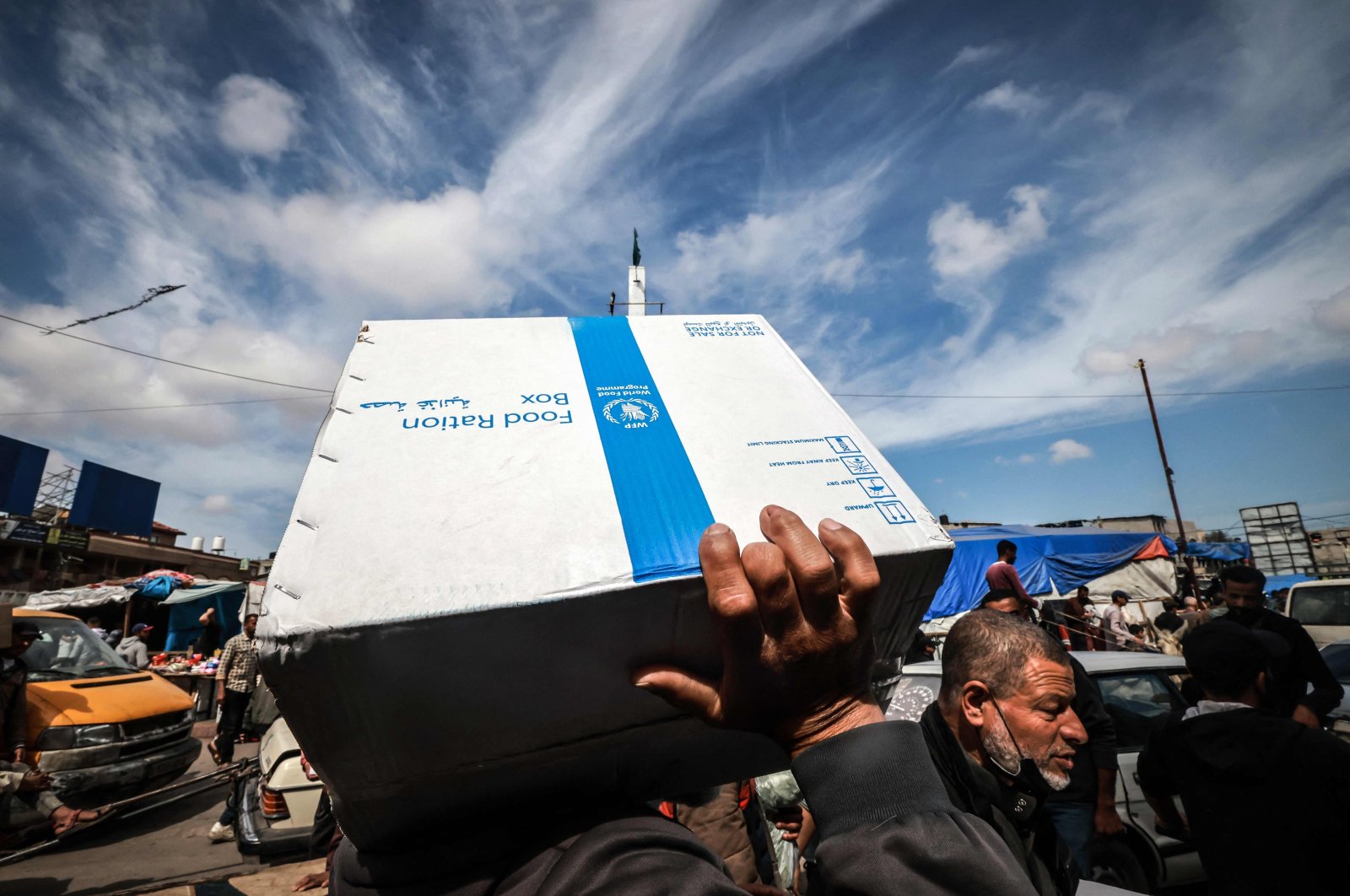 Displaced Palestinians carry a box of food rations provided by the World Food Programme in Rafah, southern Gaza Strip, Palestine, March 14, 2024. (AFP Photo)