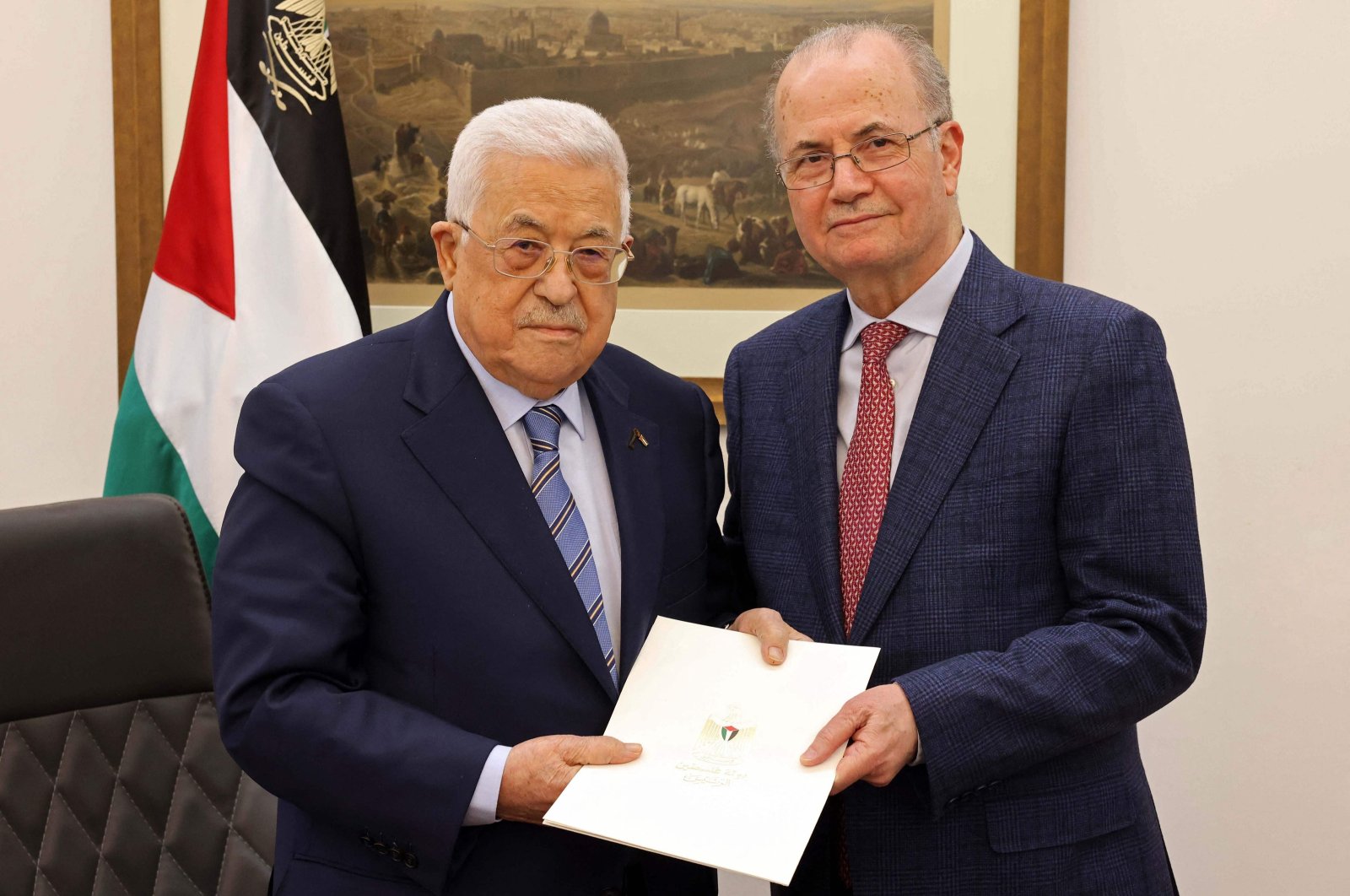 This handout picture provided by the Palestinian Authority&#039;s Press Office (PPO) shows Palestinian President Mahmoud Abbas (L) posing with the newly appointed Palestinian Prime Minister Mohammad Mustafa in Ramallah on March 14, 2024. (AFP Photo)