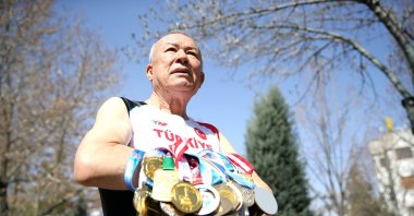 Turkish veteran athlete Ali Demirhan shows off his medals ahead of the 2024 World Masters Track Championships, Konya, Türkiye, March 12, 2024. (AA Photo)