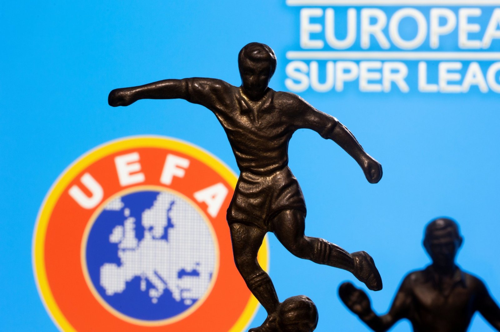 Metal figures of football players in front of the words &quot;European Super League&quot; and the UEFA logo are pictured in this illustration, April 20, 2021. (Reuters Photo)