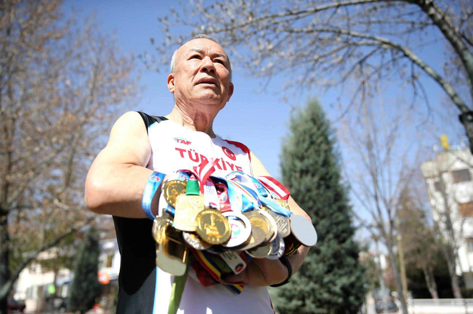 Turkish veteran athlete Ali Demirhan shows off his medals ahead of the 2024 World Masters Track Championships, Konya, Türkiye, March 12, 2024. (AA Photo)