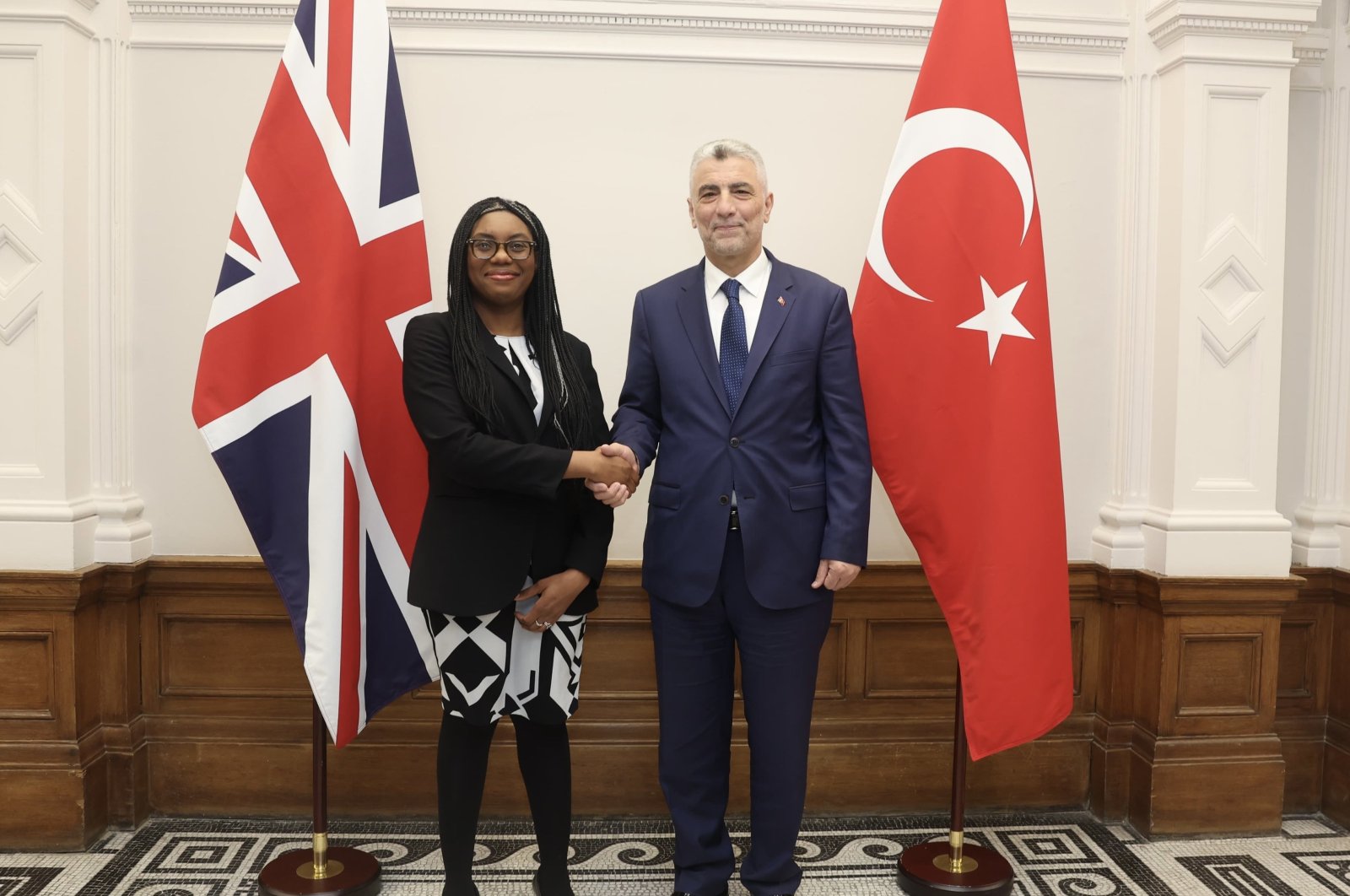Trade Minister Ömer Bolat (R) shakes hands with U.K. Business and Trade Secretary Kemi Badenoch, London, U.K., March 14, 2024. (AA Photo)