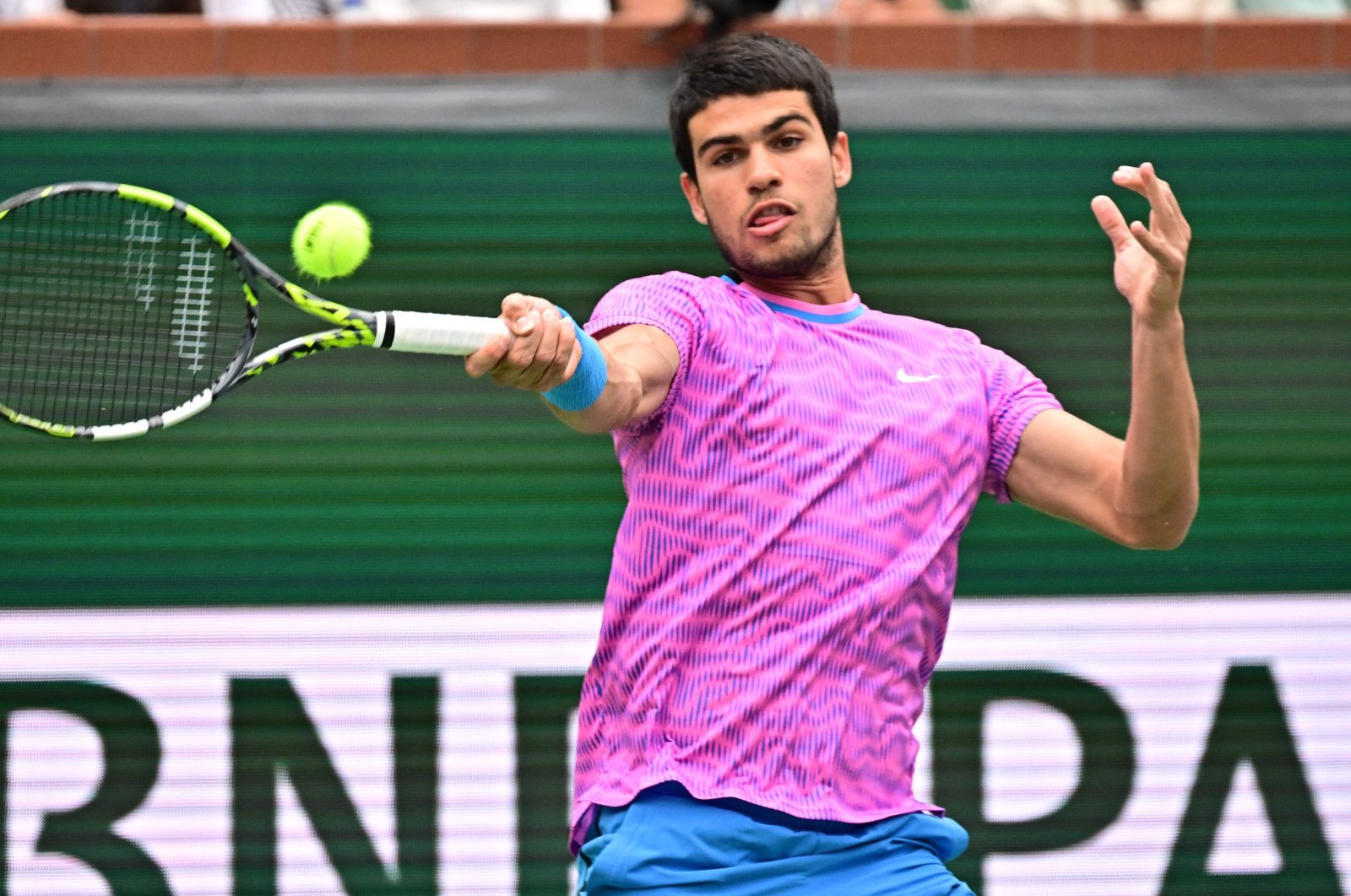 Spain&#039;s Carlos Alcaraz hits a forehand return to Italy&#039;s Jannik Sinner before a rain delay during their ATP-WTA Indian Wells Masters semifinal match, Indian Wells Tennis Garden, Indian Wells, U.S., March 16, 2024. (AFP Photo)