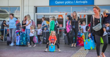 Tourists exit an airport as they arrive in the Mediterranean resort city of Antalya, Türkiye, Sept. 22, 2022. (DHA Photo)