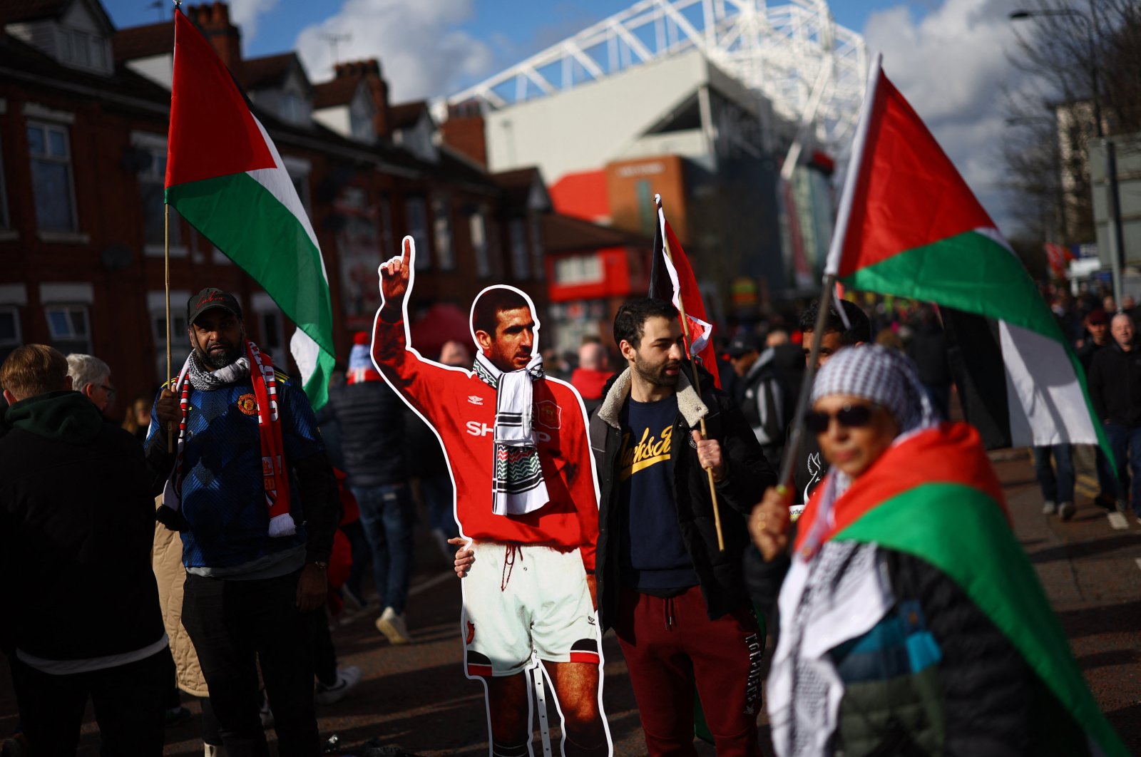 Manchester United fans carrying the flag of Palestine and a cardboard cutout of former player Eric Cantona are pictured outside Old Trafford stadium before the match against Fulham, Manchester, U.K., Feb. 24, 2024. (Reuters Photo)