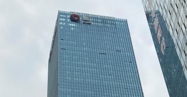 A partially removed company logo of China Evergrande Group is seen on the facade of its headquarters, Shenzhen, Guangdong province, China, Jan. 10, 2022. (Reuters Photo)