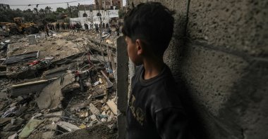 A boy watches as Palestinians search for missing people under the rubble of a destroyed house at Al-Nuseirat refugee camp, southern Gaza Strip, Palestine, March 19, 2024. (EPA Photo)