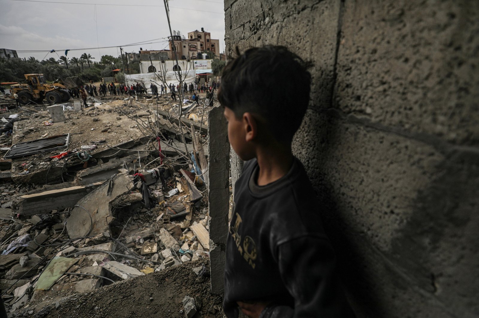 A boy watches as Palestinians search for missing people under the rubble of a destroyed house at Al-Nuseirat refugee camp, southern Gaza Strip, Palestine, March 19, 2024. (EPA Photo)