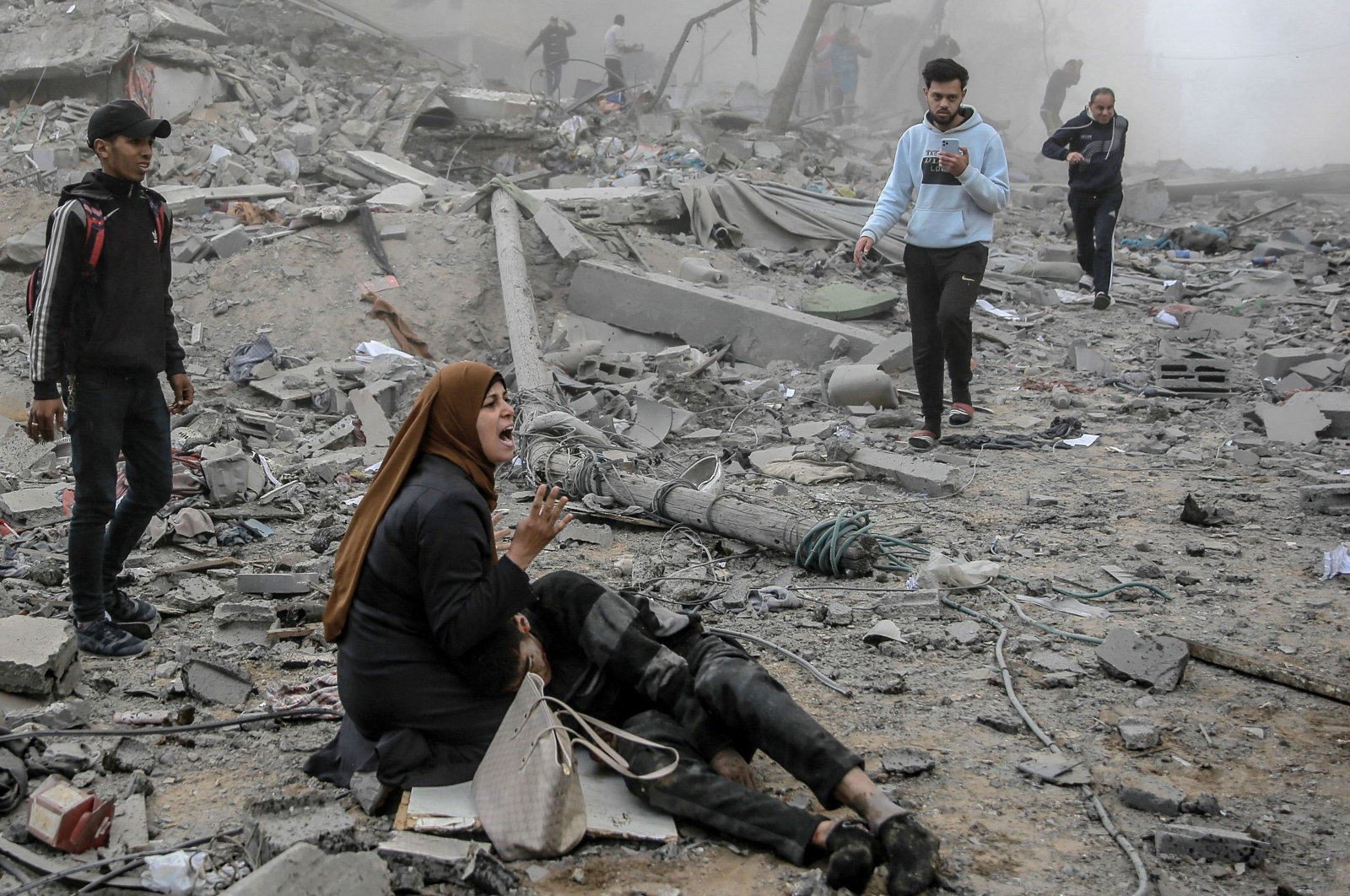 A Palestinian woman reacts as she craddles a wounded boy after the Israeli bombardment in central Gaza City, Palestine, March 18, 2024. (AFP Photo)