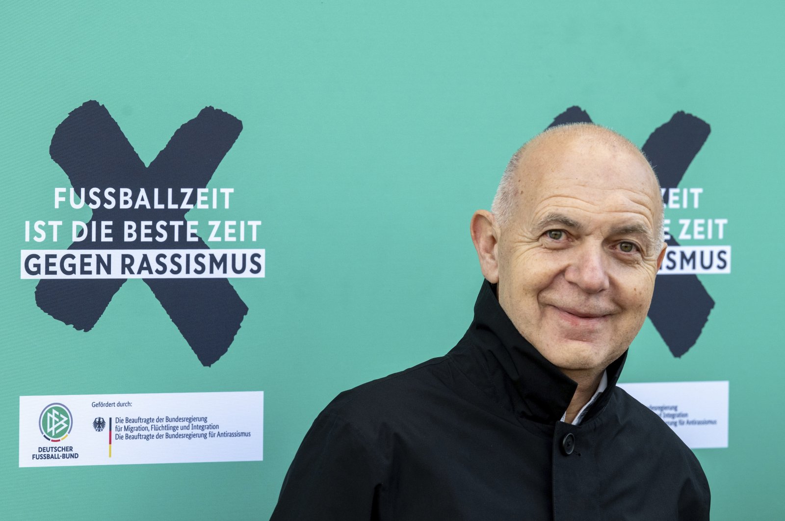 German Football Federation (DFB) President Bernd Neuendorf stands next to the campaign motto &quot;Football time is the best time against racism&quot; at the launch of the DFB&#039;s anti-racism campaign, Berlin, Germany, March 18, 2024. (AP Photo)