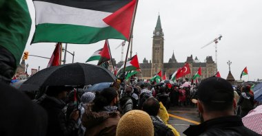 Protesters hold Palestinian flags during a rally to call for a cease-fire in Gaza, on Parliament Hill in Ottawa, Ontario, Canada, March 9, 2024. (Reuters Photo)