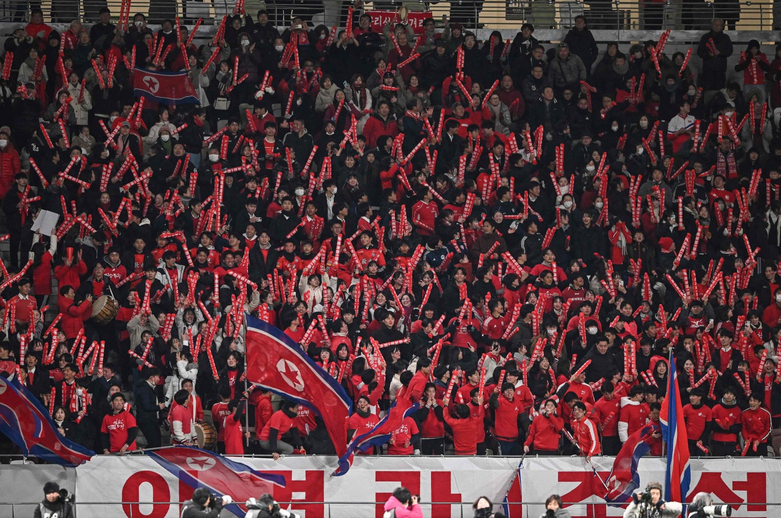 North Korean fans cheer after their team scored their first goal in the second half during the 2024 Olympic qualifying women&#039;s match between Japan and North Korea, National Stadium, Tokyo, Japan, Feb. 28, 2024. (AFP Photo)