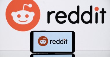 A picture shows the logo of Reddit social media displayed by a tablet and a smartphone, Toulouse, France, Oct. 5, 2021. (AFP Photo)