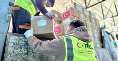An undated photo of Turkish Cooperation and Coordination Agency (TIKA) volunteers seen delivering aid packages. (AA Photo)