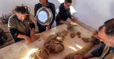 Volunteers cook portions of the traditional Libyan dish &quot;bazin&quot; in Tajura, Libya. March, 13, 2024. (AFP Photo)