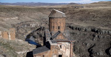 A woman walks near Tigran Honents Church in the Ani ruins near Kars, Türkiye, Feb. 28, 2024. (AFP Photo)