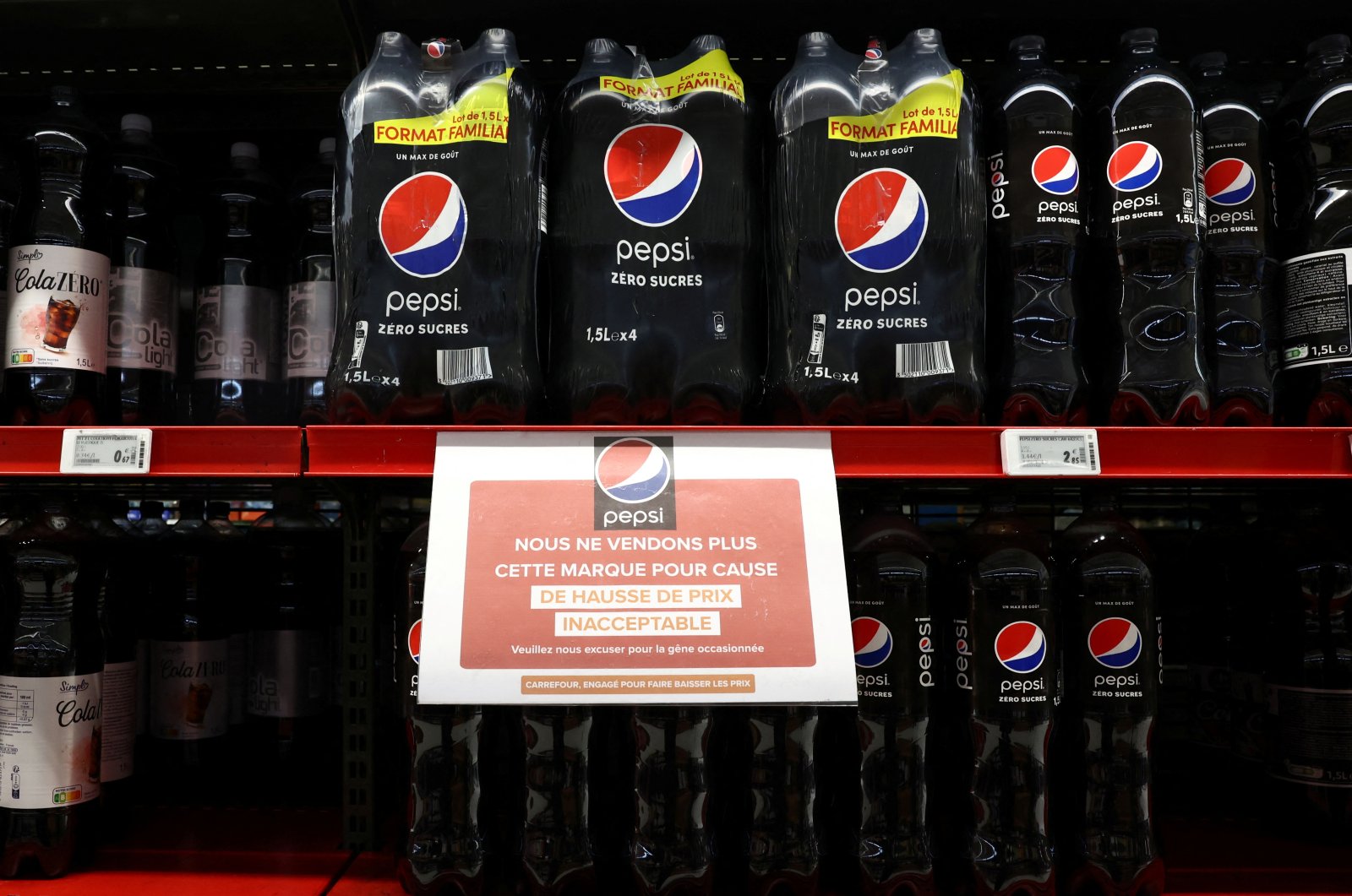 A sign reading &quot;We are no longer selling this brand due to unacceptable price increases. We apologize for the inconvenience caused&quot; is seen on a shelf for PepsiCo product Pepsi at a Carrefour hypermarket, Paris, France, Jan. 4, 2024. (Reuters Photo)
