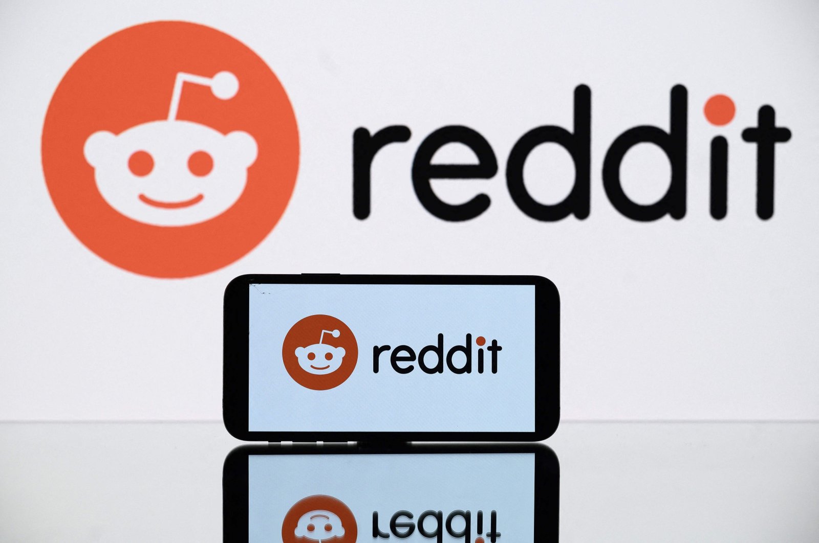 A picture shows the logo of Reddit social media displayed by a tablet and a smartphone, Toulouse, France, Oct. 5, 2021. (AFP Photo)