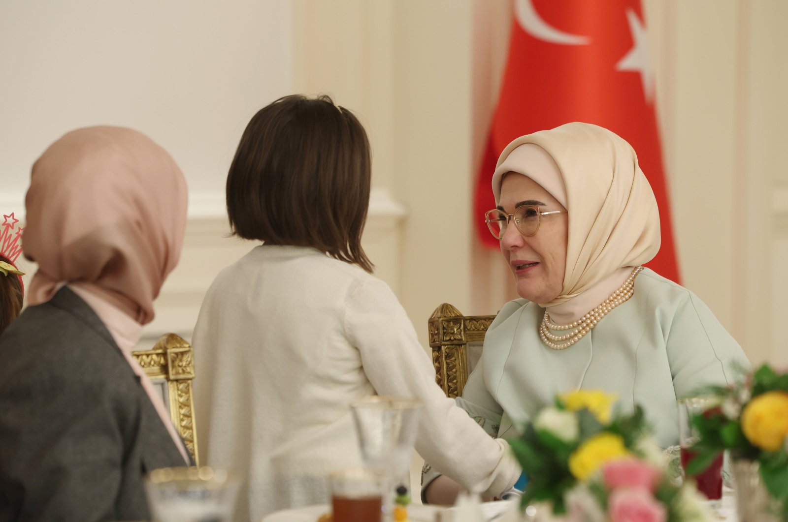 First lady Emine Erdoğan chats with a girl during an iftar event, Ankara, Türkiye, March 21, 2024. (AA Photo)