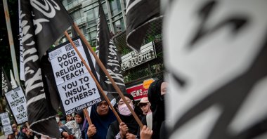 A group of women from Malaysian groups hold placards and flags while participating in a peaceful march and rally in front of the Dutch embassy protesting the desecration of a Quran by a Dutch political leader in Kuala Lumpur, Jan. 27, 2024. (Reuters File Photo)