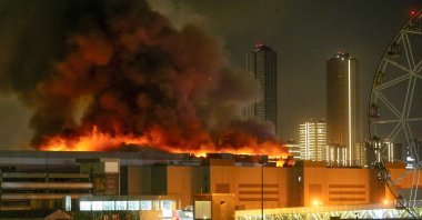 A massive blaze is seen over the Crocus City Hall on the western edge of Moscow, Russia, Friday, March 22, 2024. (Moscow News Agency via AP)
