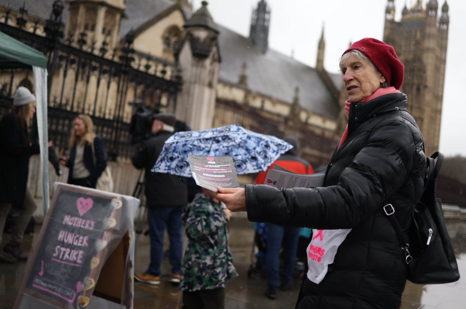 A food poverty campaigner with Mother&#039;s Manifesto hands out fliers as they demonstrate outside Parliament on Mother&#039;s Day, London, Britain, March 10, 2024. (EPA Photo)