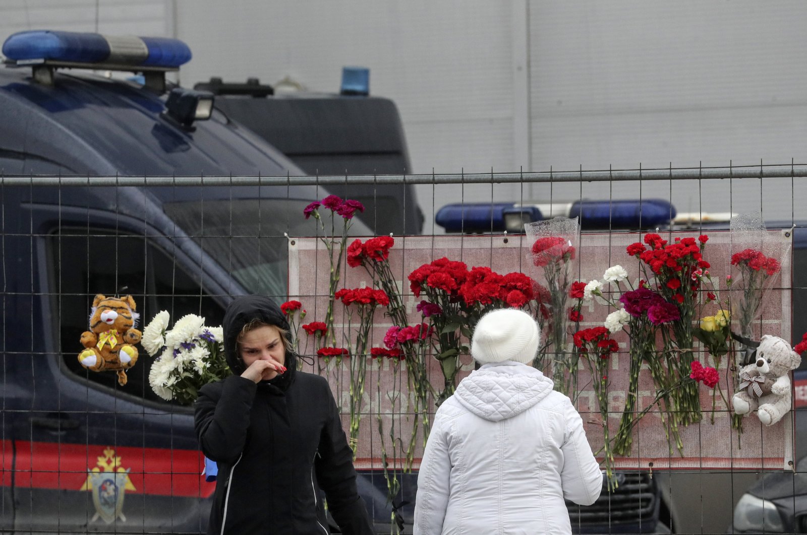People bring flowers to the burned Crocus City Hall concert venue following a terrorist attack in Krasnogorsk, outside Moscow, Russia, March 23, 2024. (EPA Photo)